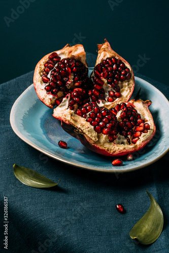 Fresh ripe pomegranate open on plate