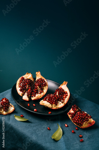 Fresh ripe pomegranate open on plate