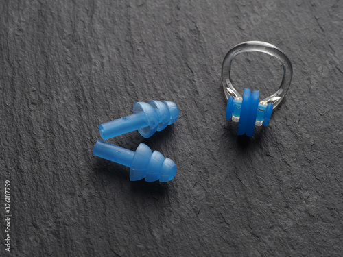 Canvas Print Nose clip and ear plugs for swimming pool on a gray background