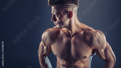 Fotografía Shirtless male bodybuilder with muscular build strong abs showing