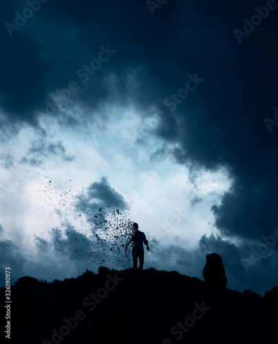 Man disintegrates on hill, conceptual image