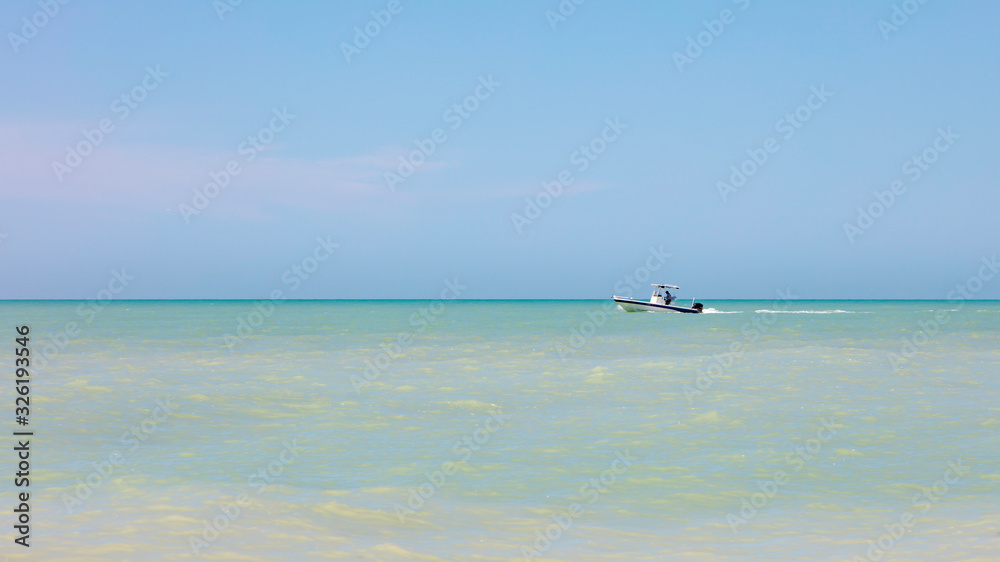 Calm ocean with boat,  Florida, USA