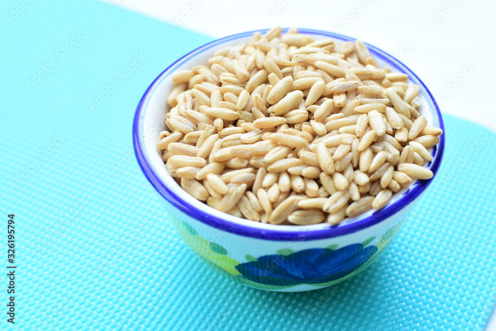 Oat grains accompanied by wheat ears in containers for display Oat grains accompanied by wheat ears in containers for display