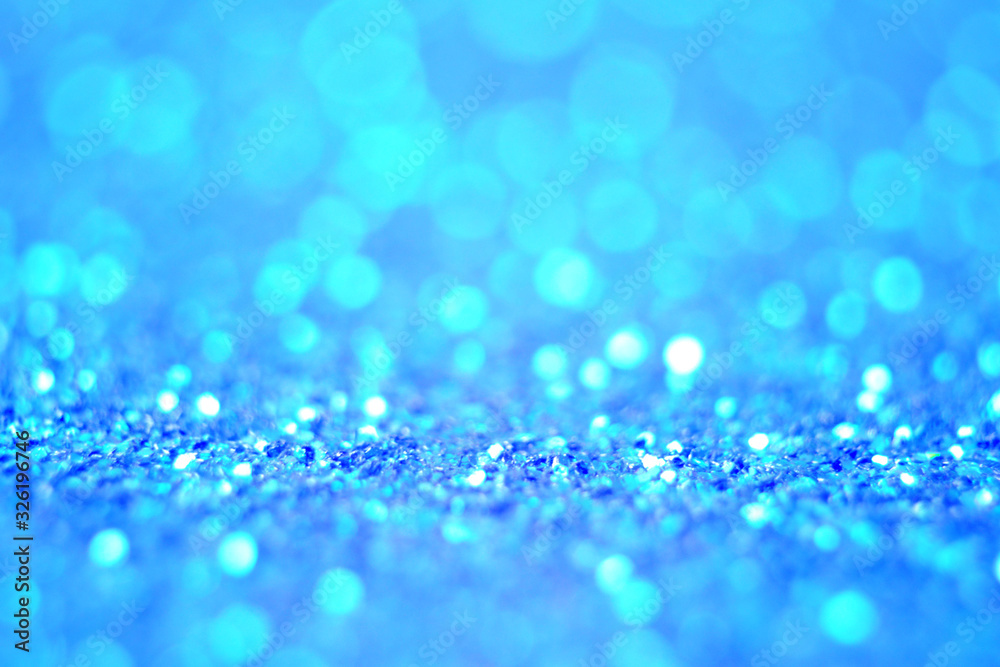 Obraz premium Lights on blue defocus background. Bokeh defocus disco effect. Holiday abstract background christmas lights garland. Winter festive shine sparkle glitter macro concept in blue color