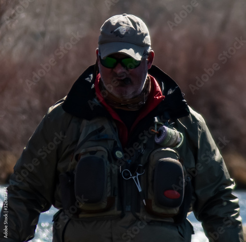 A man fly fishing on the San Jaun river in the winter. © phillips