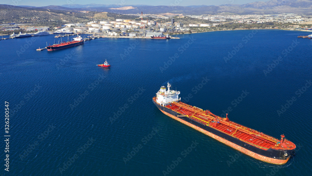 Aerial drone photo of huge fuel tanker ship docked in industrial area of Elefsina, Attica, Greece