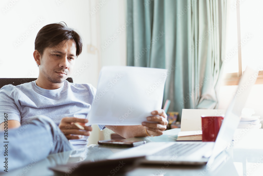 Young asian man working and Check With documents Young asian man working and Check With documents