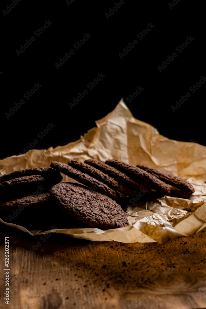 Chocolate chip cookies on dark old wooden table with place for text., freshly baked. Selective Focus with Copy space.