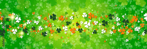 St.Patrick's Day green vector background with clover leaves and light effects	