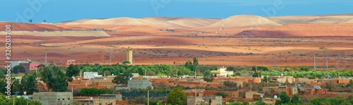 Panoramic view of High Atlas Mountains with the town at the foot of the colorful mountains in Morocco