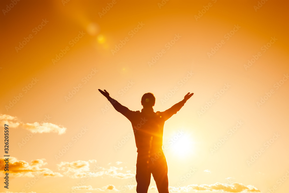 silhouette against the sky with hands up symbolizing freedom. business success concept. achievements in sports and yoga.