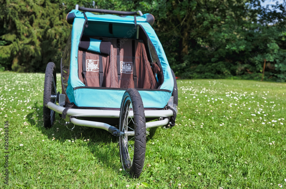 Empty bicycle trailer with front wheel in a park Empty bicycle trailer with front wheel in a park