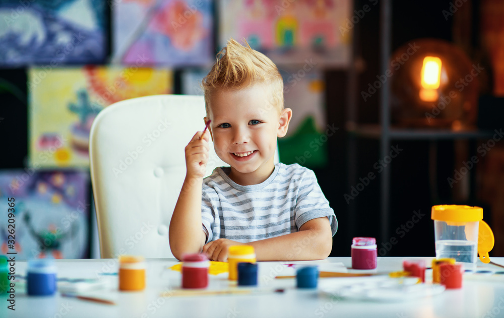 funny child boy draws laughing with paint. funny child boy draws laughing with paint.