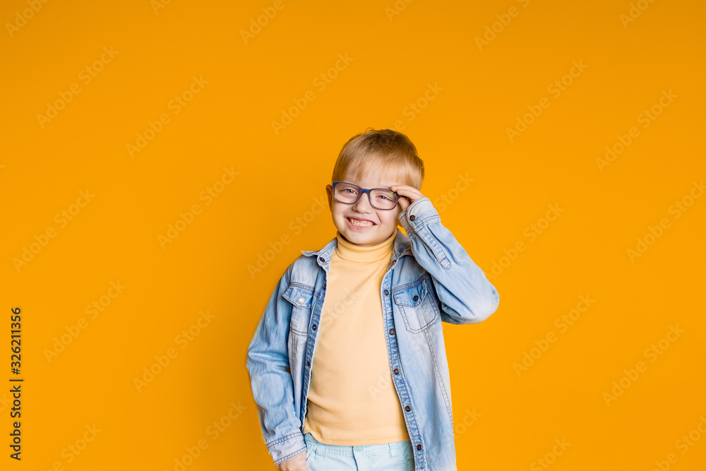 funny kid schoolboy boy with books on yellow background