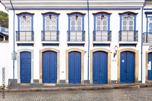 Vibrant blue and yellow colour scheme on the facade of a typical historic colonial facade in the city centre of Ouro Preto