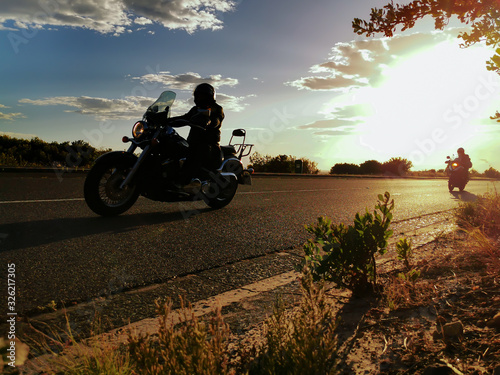 Fototapeta Naklejka Na Ścianę i Meble -  biker on harley riding at dawn