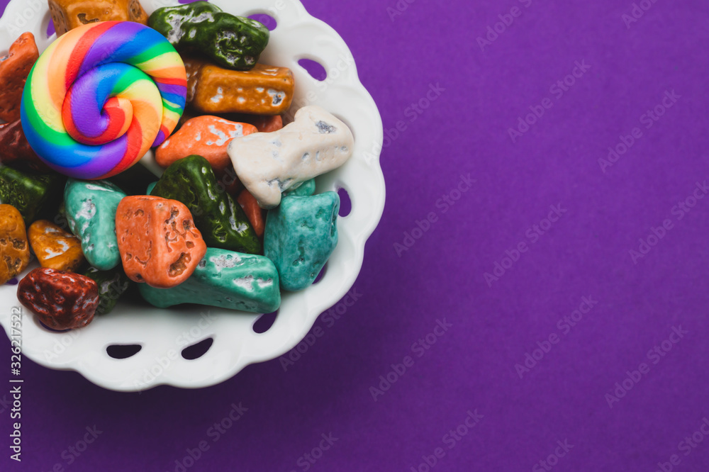 Lollipops and candy pebbles. sweets in the form of colored stones. colored background with colorful candies Lollipops and candy pebbles. sweets in the form of colored stones. colored background with colorful candies