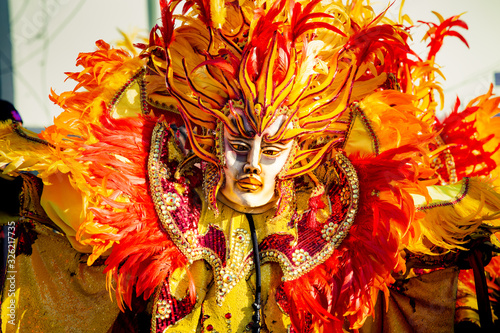 closeup person in flamboyant costume poses for photo at dominican carnival photo