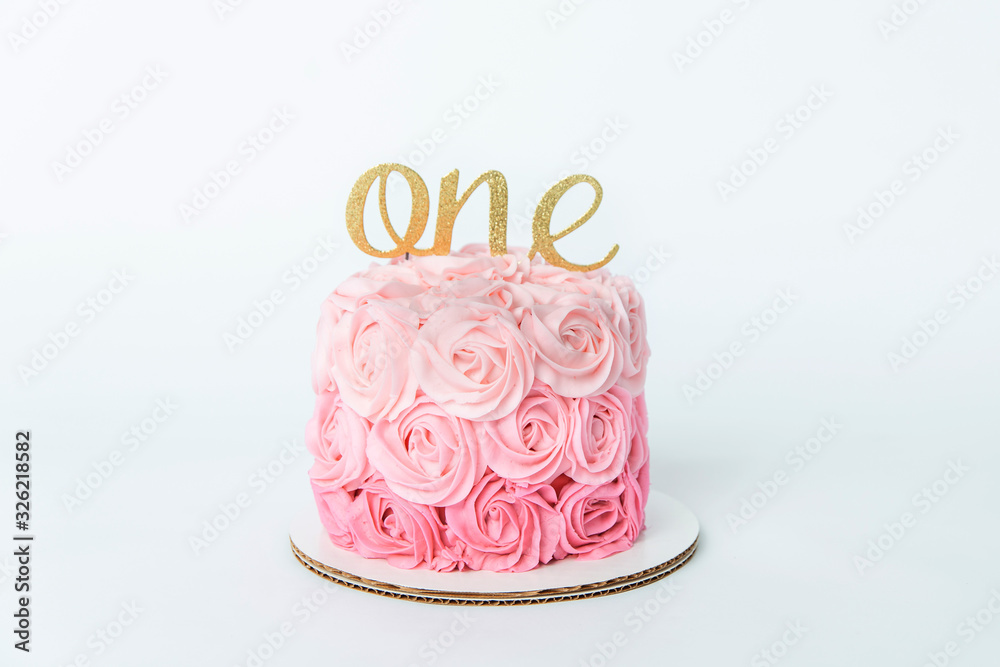 white studio backdrop with shades of pink ombre rosettes in buttercream icing frosting on a first birthday cake fior a cake smash white studio backdrop with shades of pink ombre rosettes in buttercream icing frosting on a first birthday cake fior a cake smash