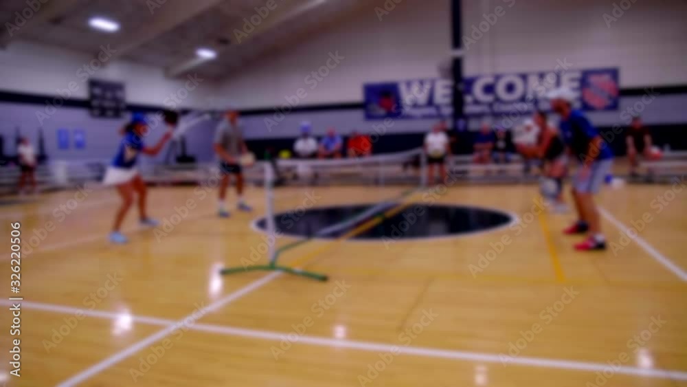 SOFT FOCUS SHOT OF A FOURSOME PLAYING PICKLEBALL. ALL PLAYERS UNRECOGNIZABLE. SLOW MOTION FULL HD AT 180 FPS. SOFT FOCUS SHOT OF A FOURSOME PLAYING PICKLEBALL. ALL PLAYERS UNRECOGNIZABLE. SLOW MOTION FULL HD AT 180 FPS.