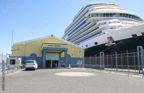 Cruise Ship Terminal at Gibraltar Port, United Kingdom.  Unidentifiable Cruise tied up at dock.  Cruise Terminal Sign has been altered to Generic Markings.