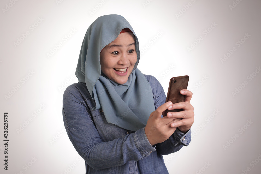 Young Muslim Woman Get Good News on Her Phone Young Muslim Woman Get Good News on Her Phone
