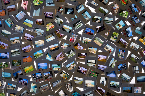 Top view of collection of film slide snapshot pictures on a light table