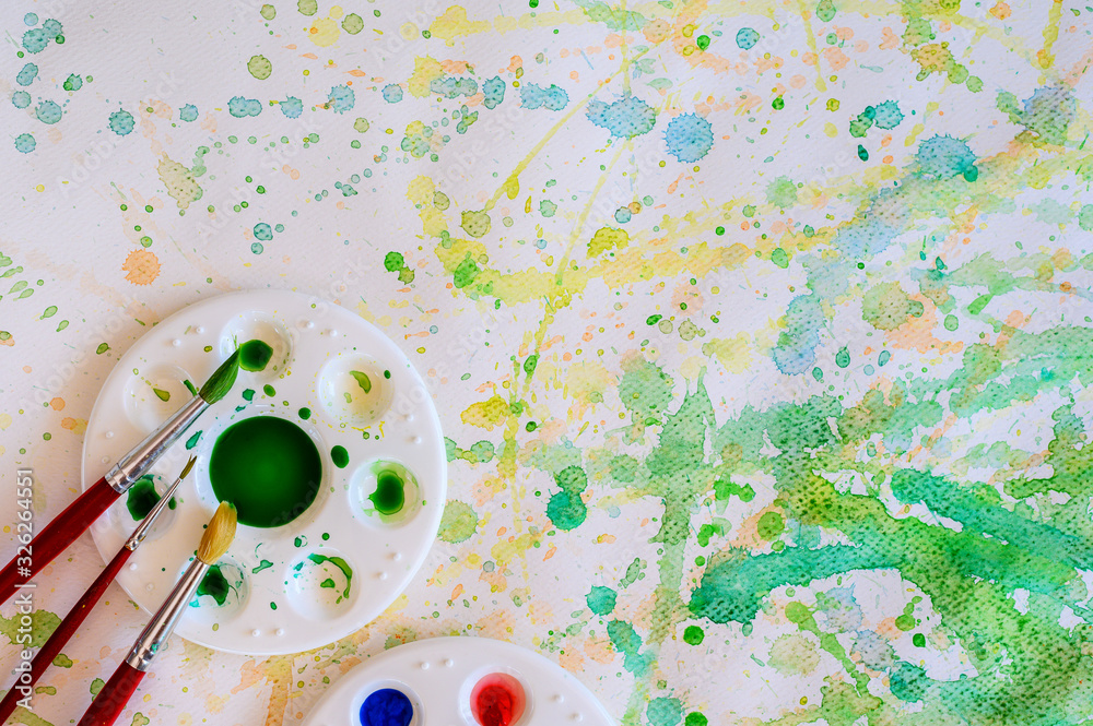 Φωτογραφία Paintbrush and watercolor paint, Palettes on the white paper smear the color, top view