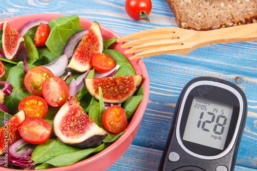Fruit and vegetable salad and glucometer, concept of diabetes and healthy nutrition
