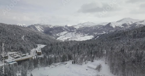 Wallpaper Mural Breathtaking fly over frozen snowy fir and pine trees on distant mountains background. Nature concept. Winter time, coziness, enjoying the landscape. cozy village,wild nature. Bakuriani ski resort Torontodigital.ca