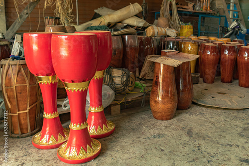 .Long drum painted in alternating red and gold for beauty
