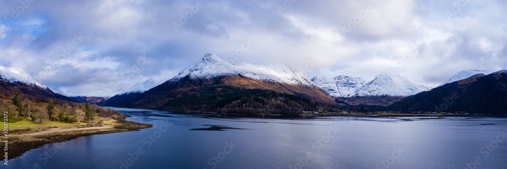 aerial drone shot of winter in glencoe and and loch Leven in the argyll region of the highlands of scotland showing clear bright white snow on the mountains of glencoe and the surrounding region