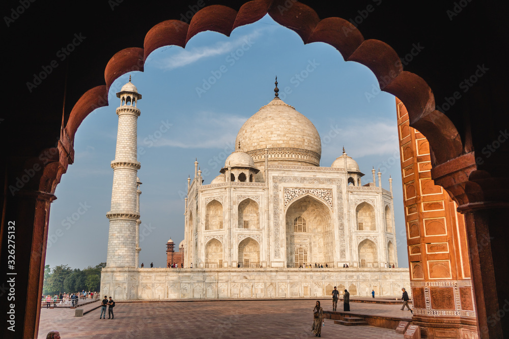 view of taj mahal from an marble arch frame