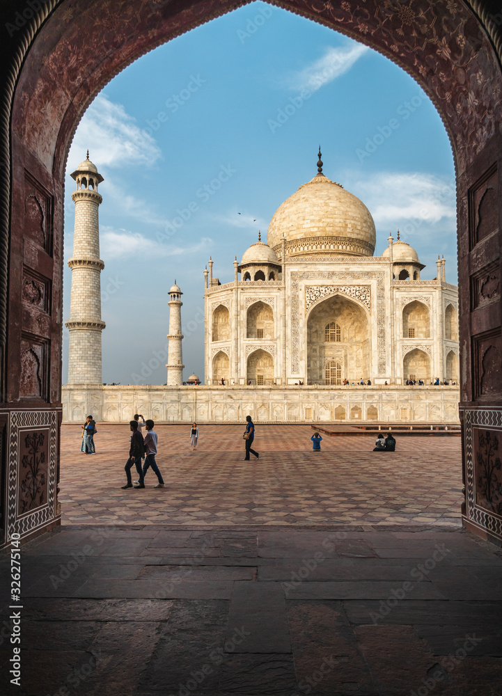 Fototapeta premium view of taj mahal from an marble arch frame vertical