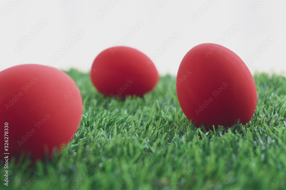 red easter egg on lawn green grass artificial with blank white background red easter egg on lawn green grass artificial with blank white background