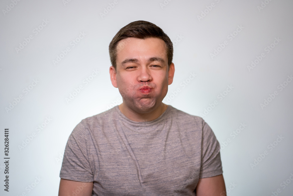 A man with his mouth full of food closed.