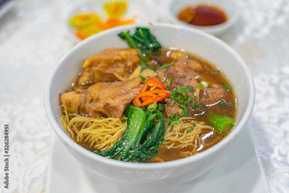 Delicious Chinese styled braised beef noodle soup on white background Delicious Chinese styled braised beef noodle soup on white background