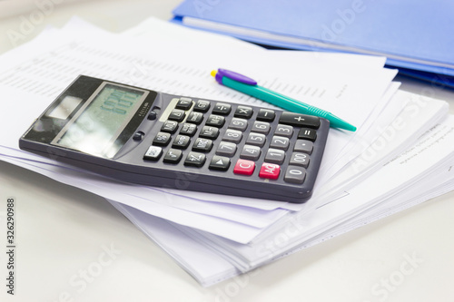 calculator with business paper on table in work office, concepts business and cost and financial planning