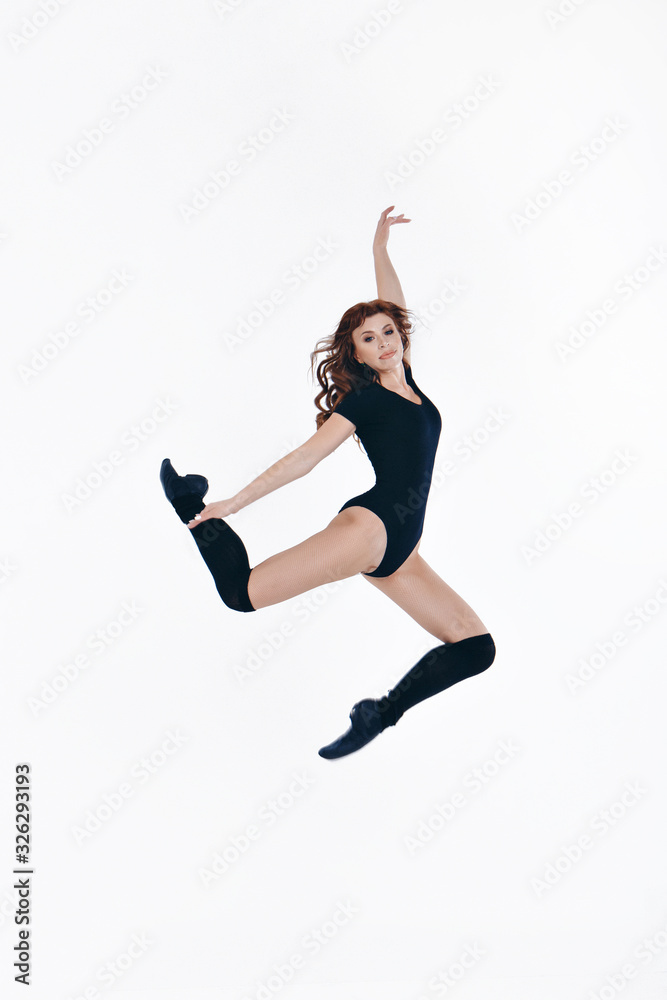 Girl in a tracksuit for on a white background. Gymnast in the jump. Healthy lifestyle concept, sports uniforms, world Cup, gym, specialized clothing, black uniforms, exercise