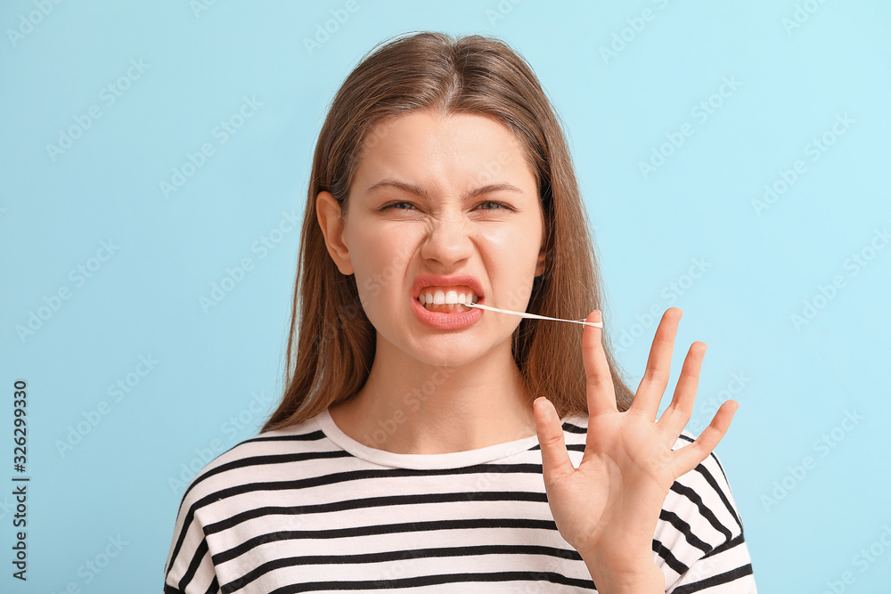 Funny young woman with chewing gum on color background Funny young woman with chewing gum on color background