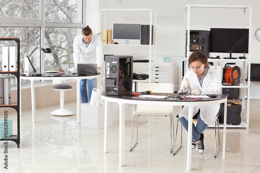 Electronic technicians working in service center Electronic technicians working in service center