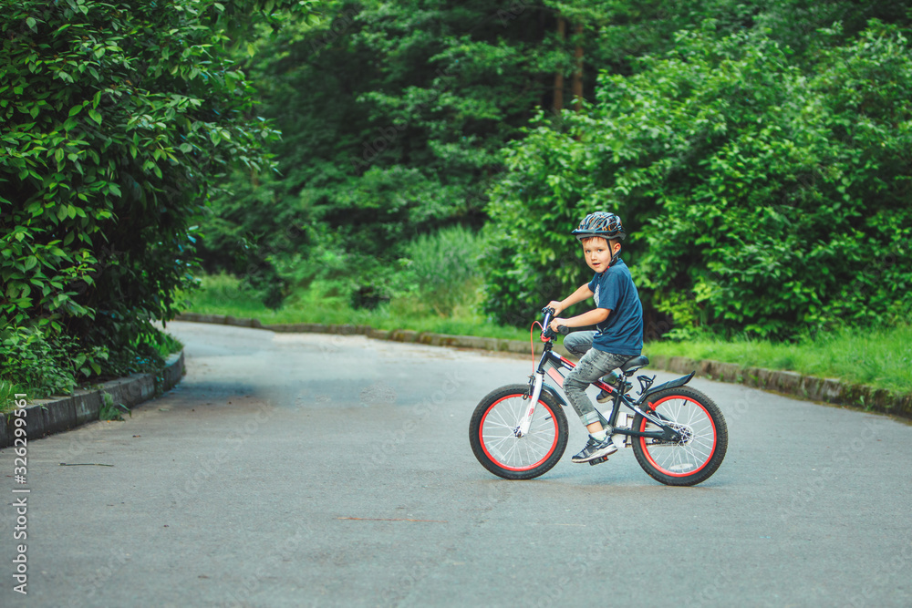 little boy riding on bicycle in helmet little boy riding on bicycle in helmet
