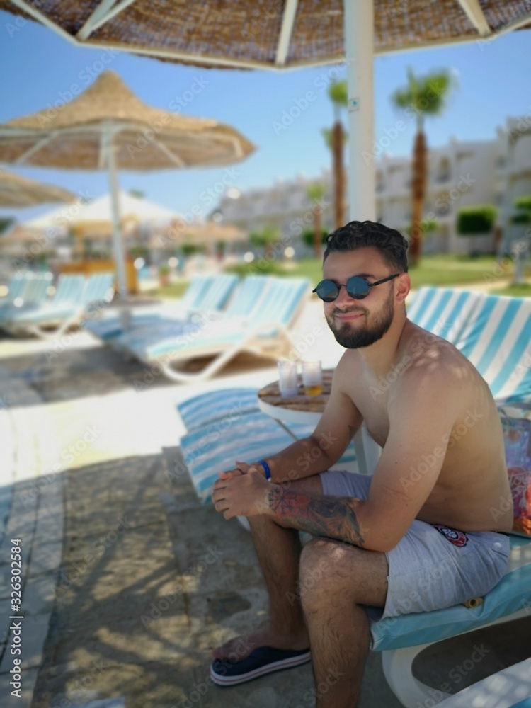 man by the pool , relax and high, smile man by the pool , relax and high, smile