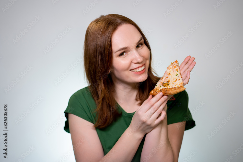 woman brown hair holding piece of pizza, laughs woman brown hair holding piece of pizza, laughs