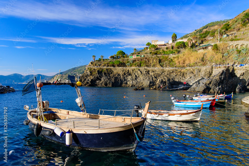 Fishing boats at Manarola, one of the five Mediterranean villages in Cinque Terre, Italy, famous for its colorful houses and harbor