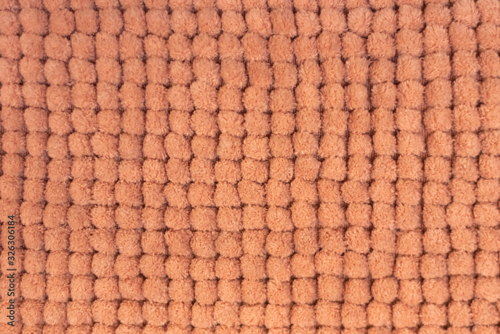 Blurred texture of soft orange flannel rug. Soft honeycomb background. Blurred texture of soft orange flannel rug. Soft honeycomb background.