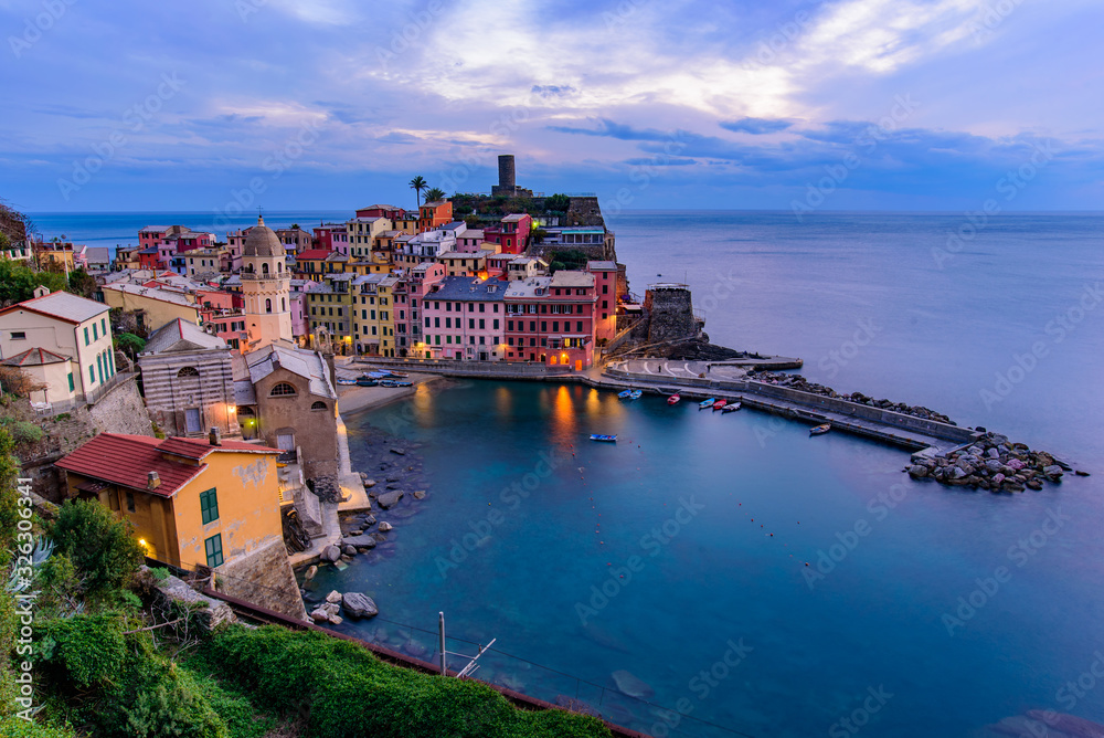 Sunset view of Vernazza, one of the five Mediterranean villages in Cinque Terre, Italy, famous for its colorful houses and harbor