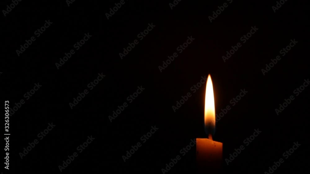 Close-up of a Candlelight Isolated on a Black Background, candlelight is calm because there is no wind Close-up of a Candlelight Isolated on a Black Background, candlelight is calm because there is no wind