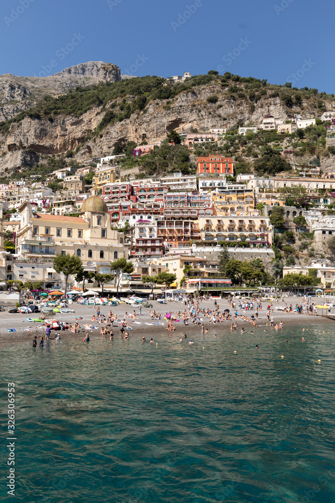  People are resting on a sunny day at the beach in Positano on Amalfi Coast in the region Campania, Italy