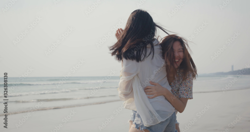Girlfriends couple LGBT young asian run playing catch on seaside beach, Freedom relaxation, resting summer vacation sunset people lifestyle concept Girlfriends couple LGBT young asian run playing catch on seaside beach, Freedom relaxation, resting summer vacation sunset people lifestyle concept